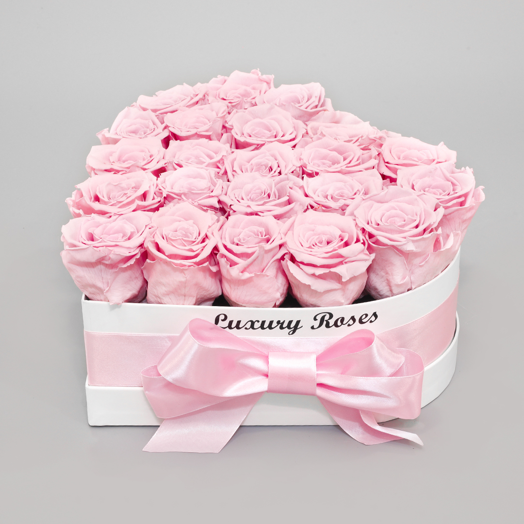 Luxury white heart-shaped box with everlasting pink roses